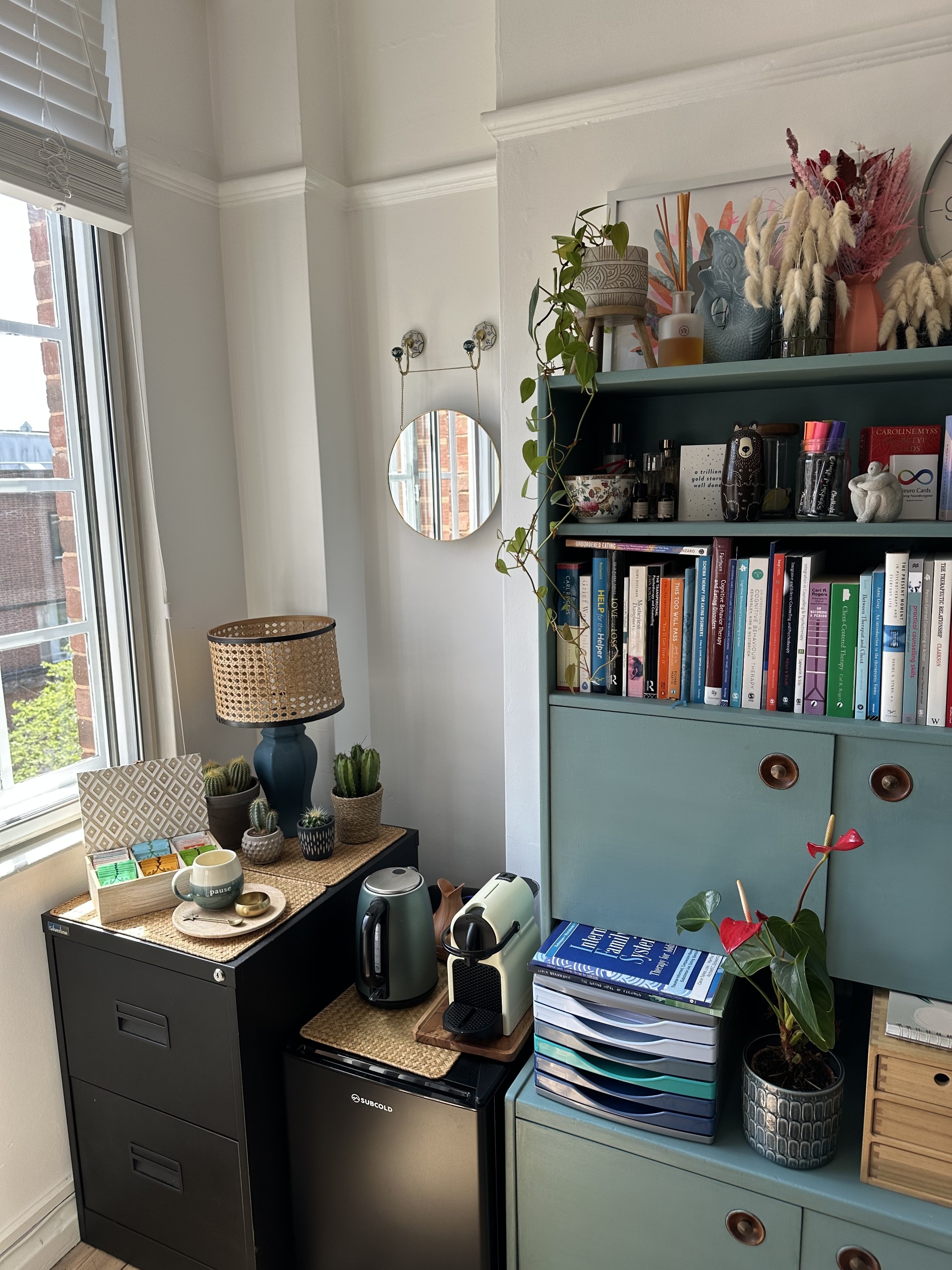 A corner of the therapy room with a bookshelf and reading nook